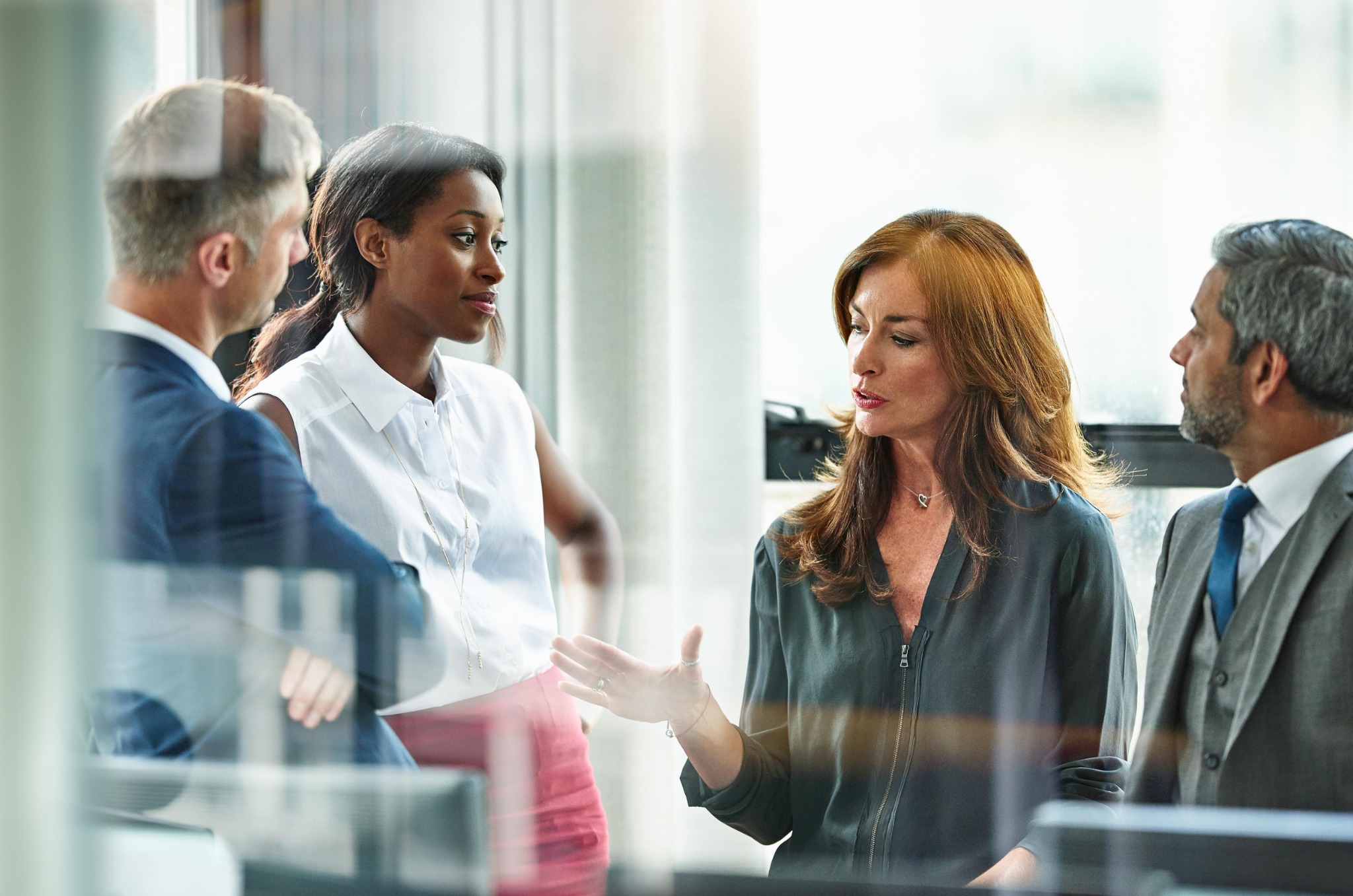 Professionals exchanging perspectives during a workplace leadership conversation